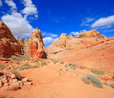 United states a clear blue sky with fluffy white clouds above the slot canyons near las vegas explore nevada’s hidden desert gems