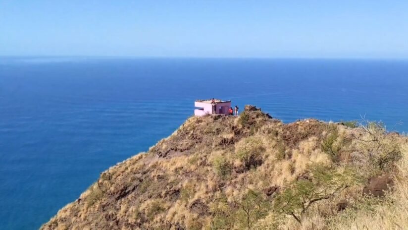 A Pink House Atop A Mountain, Overlooking The Ocean, With The Maili Pillbox In View