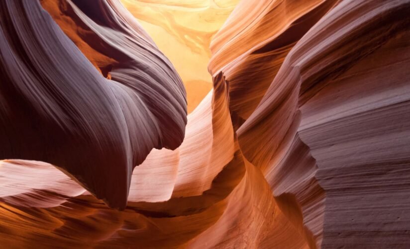 A View Of Lower Antelope Canyon, Arizona, Featuring Vibrant Sandstone Walls And Winding Corridors Shaped By Erosion