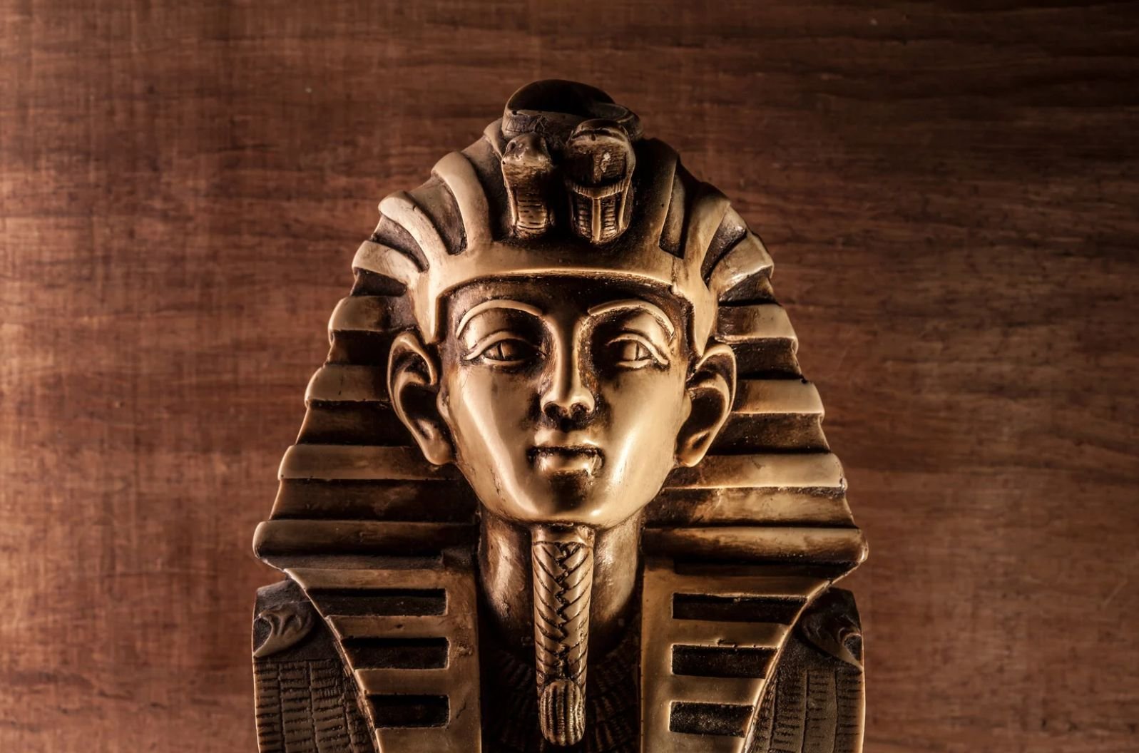 An Egyptian Statue Of A Pharaoh, Showcasing Intricate Details And Traditional Attire, Symbolizing Ancient Royalty