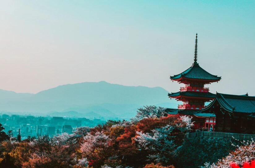 In The Foreground, A Pagoda Is Framed By Mountains In The Background, Highlighting The Picturesque Landscape Of Kyoto, Japan