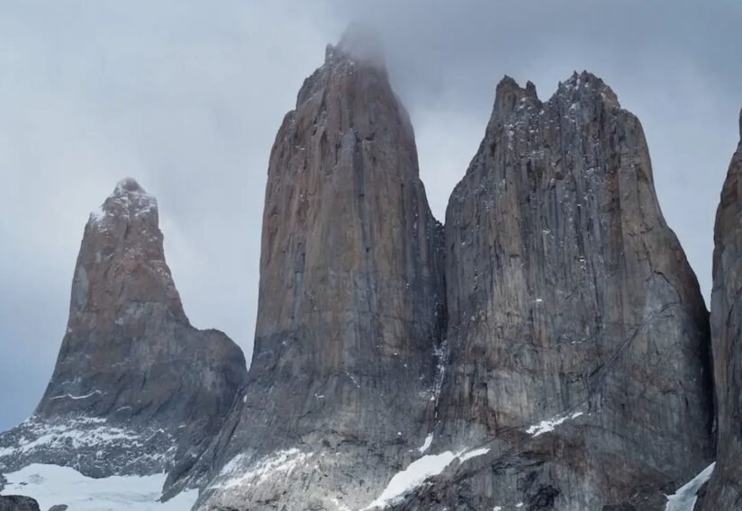 Majestic Scene At Mirador Las Torres, With Mountains Bordered By Water And Other Mountain Ranges In The Distance