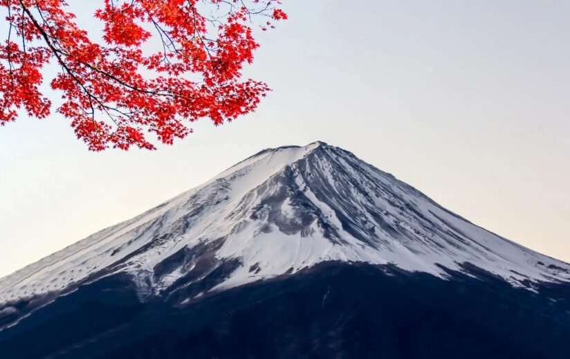 Mount Fuji Surrounded By Vibrant Autumn Colors, Showcasing Japan's Natural Beauty During The Fall Season