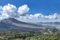 Indonesia scenic view from mount batur, showcasing sunrise over trunyan hill, highlighting bali's natural beauty and tranquility hill hike hidden trek for culture, solitude & epic views