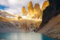 Chile scenic view of mirador las torres, featuring mountains surrounded by water and additional mountain ranges in the background torres hike your complete 1-day trek guide from puerto natales