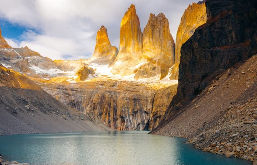 Scenic View Of Mirador Las Torres, Featuring Mountains Surrounded By Water And Additional Mountain Ranges In The Background