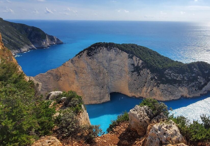 Scenic View Of Navagio Beach, Zakynthos Island, Greece, Showcasing Its Iconic Shipwreck And Stunning Blue Waters