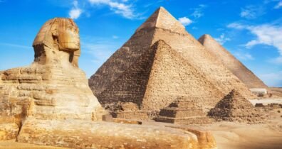 The great sphinx and pyramids of giza, showcasing ancient egyptian architecture against a clear blue sky