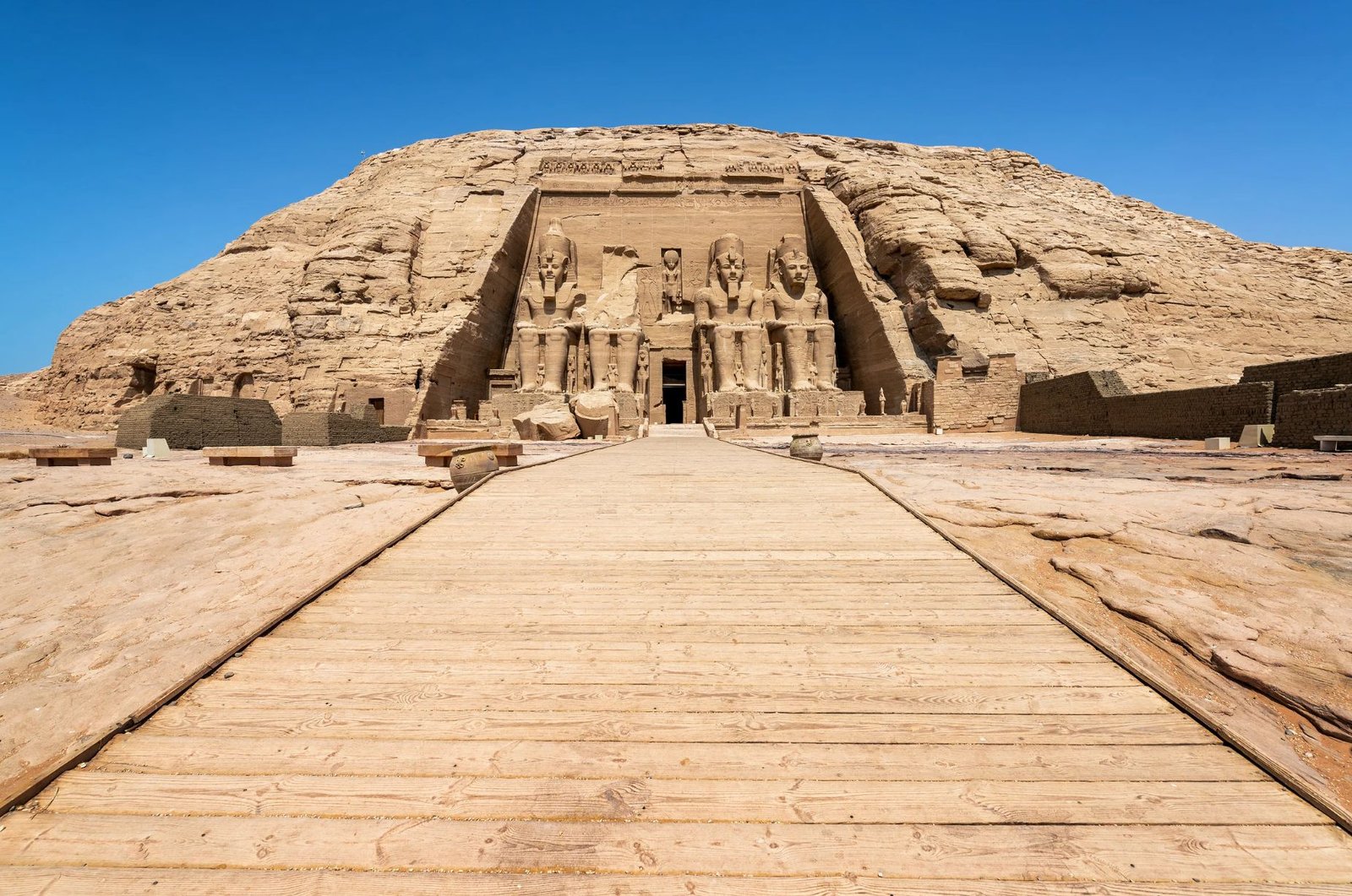 The Grand Abu Simbel Temple In Egypt, Showcasing Colossal Statues And Ancient Egyptian Architecture Against A Desert Backdrop