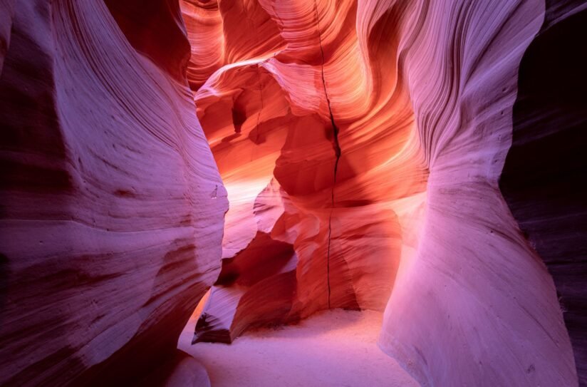 The Narrow, Winding Passage Of Antelope Canyon X In Arizona, Featuring Smooth, Colorful Sandstone Walls Illuminated By Sunlight