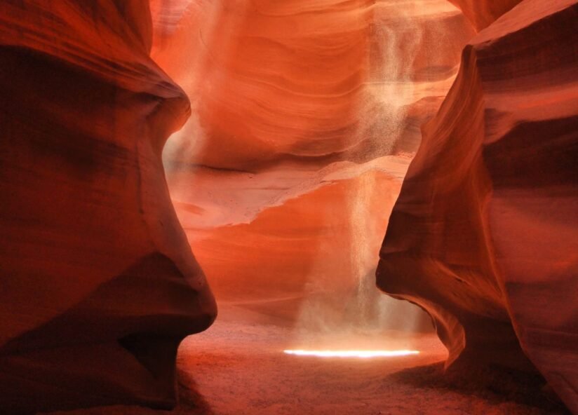 The Sun Shines Through Antelope Canyon X In Arizona, Casting Beautiful Light Patterns On The Smooth, Sculpted Rock Surfaces
