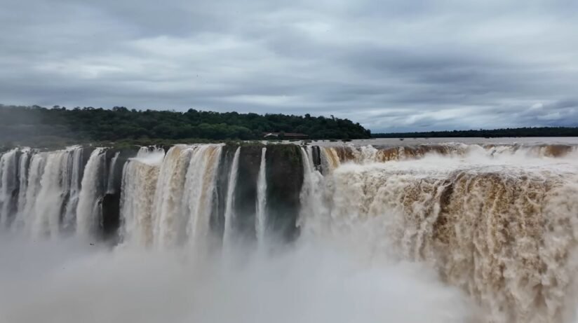 Water Cascades Down The Steep Cliffs Of Iguazu Falls, Creating A Powerful And Breathtaking Waterfall Scene