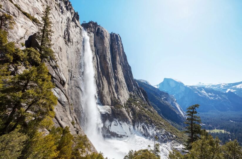 Yosemite Falls Cascading Down In Yosemite National Park, California, Showcasing The Park's Stunning Natural Beauty